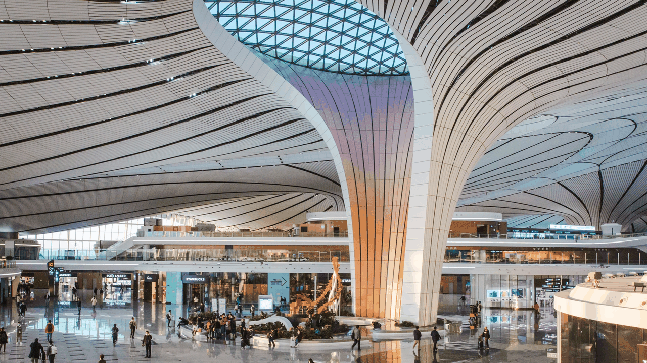 Sunset glow over the “phoenix-wing” terminal of Beijing Daxing International Airport, December 2025