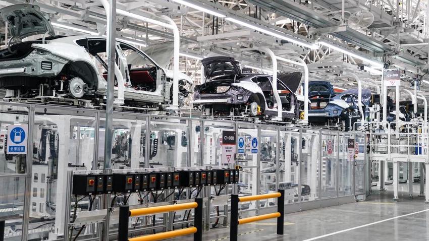 Automobile assembly line: car bodies on production equipment in a factory.