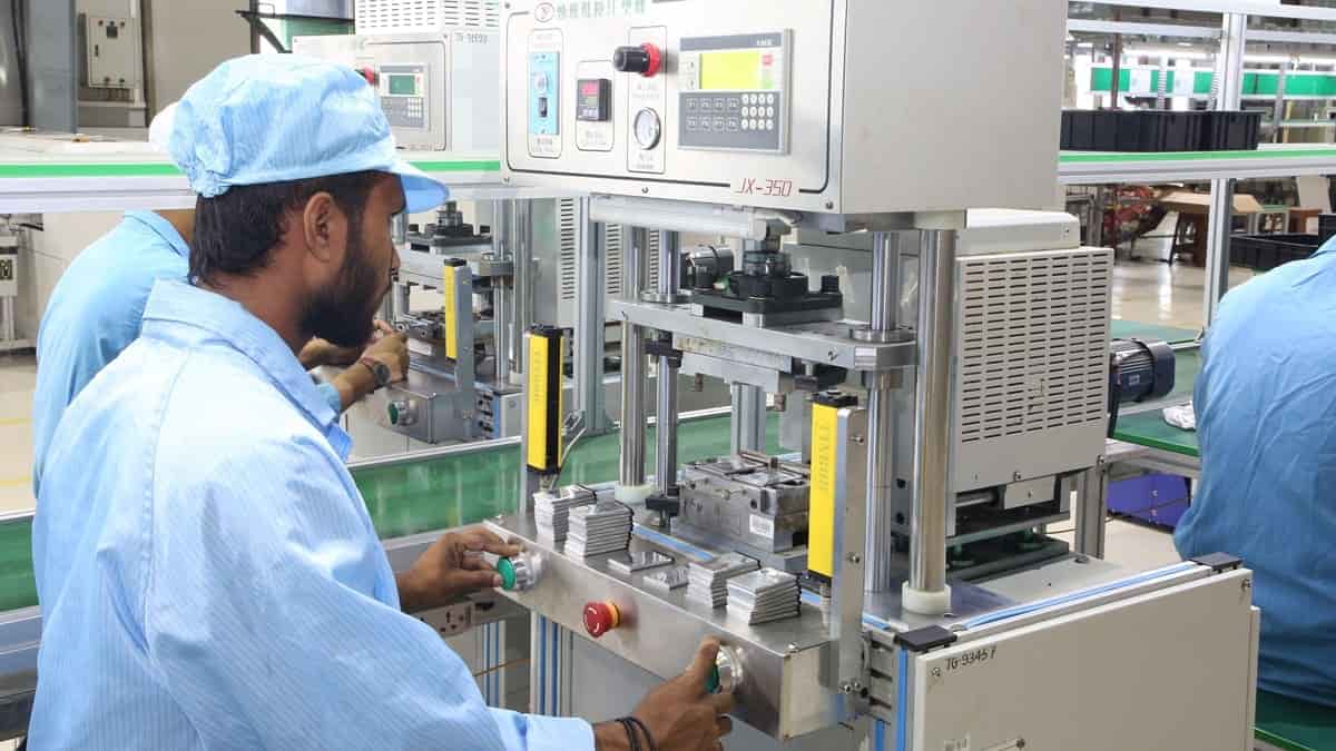 Worker operating machinery in electronics factory